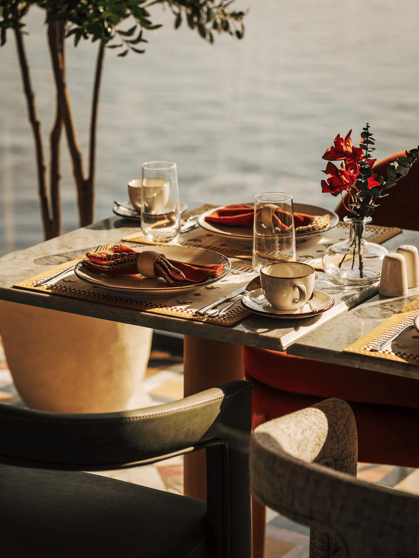 Waterside breakfast table set with ceramics and fresh flowers